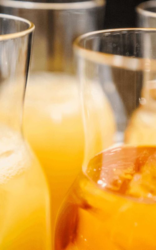 Æble- og appelsinjuice i glaskander på buffet til brunch